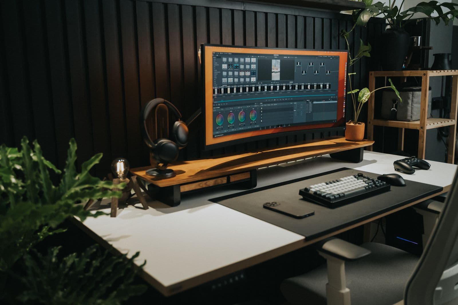 A minimalist desk workspace with a monitor in low evening light