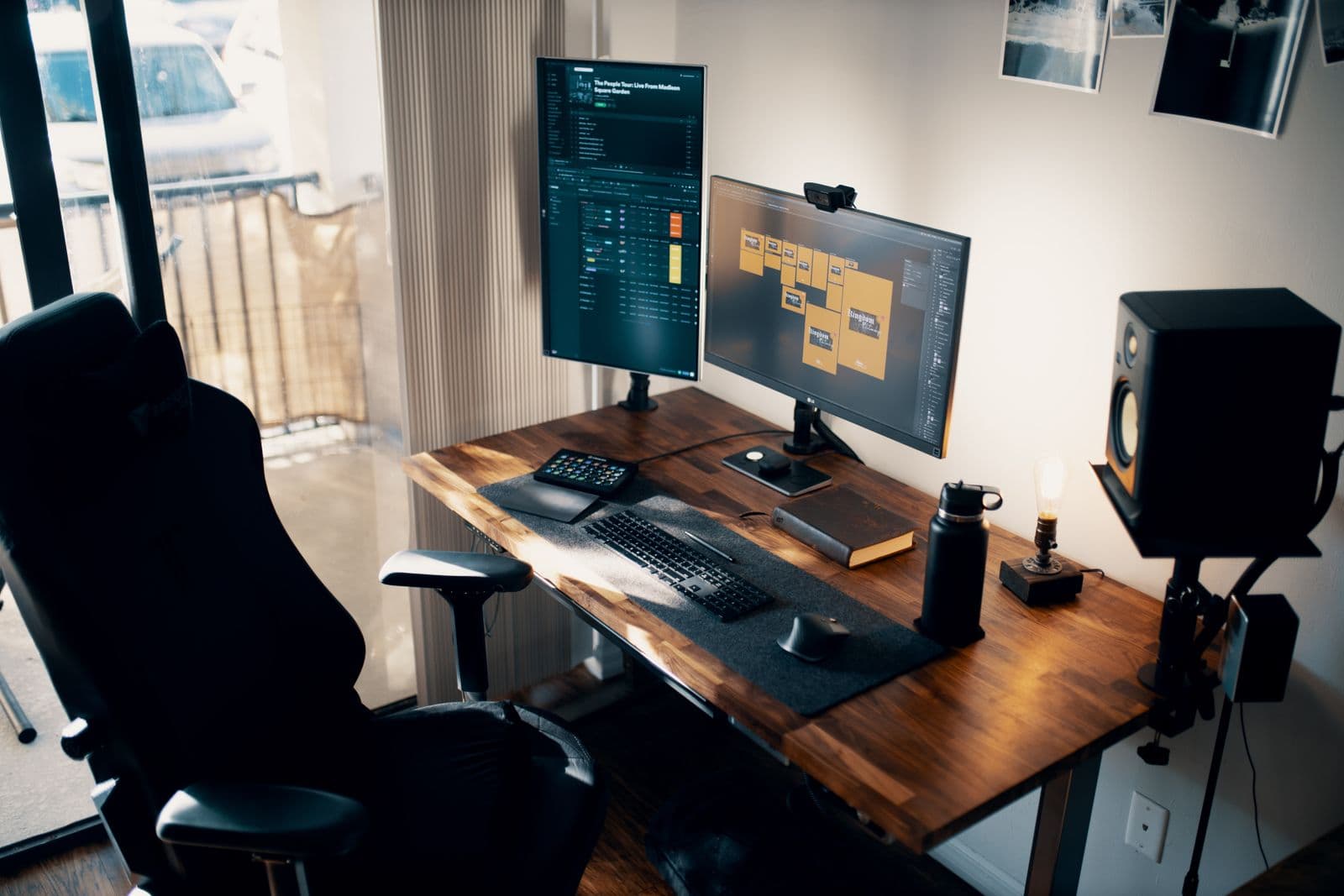A desk with two monitors, a keyboard and an ergonomic chair