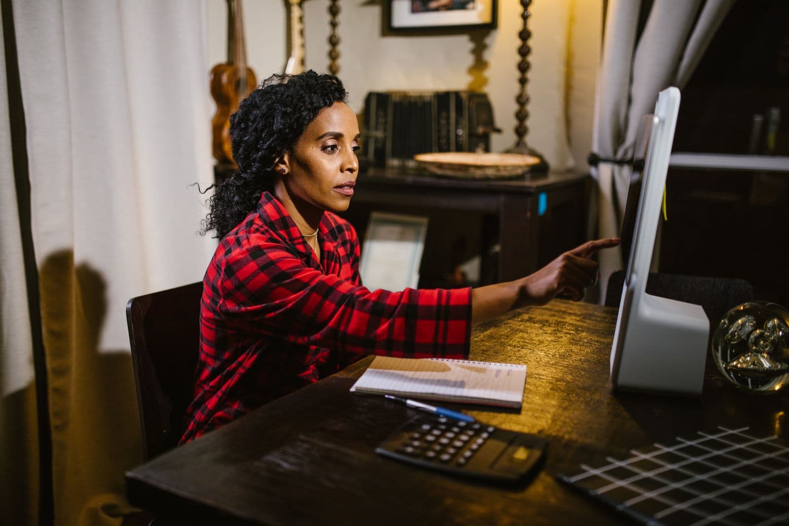 A woman working at a computer in a home office