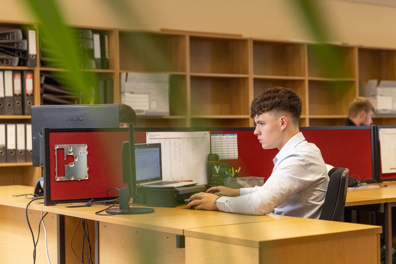 A man working at a computer in a bright contemporary office